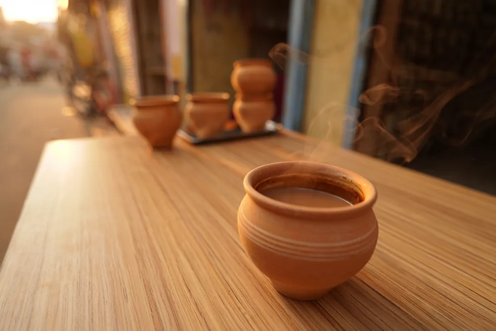 Traditional unglazed clay kulhad cup filled with hot chai